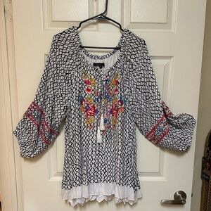 A Calessa brand feminine blouse. New w/out tags, size 1X.